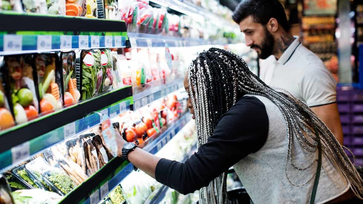 A mixed ethnicity couple shopping for food in a supermarket