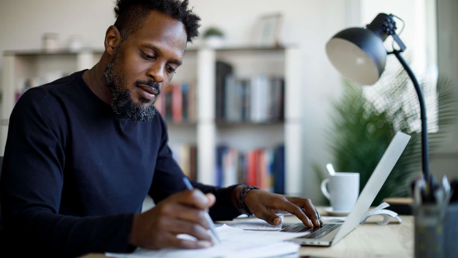 Middle-aged black male working at home desk