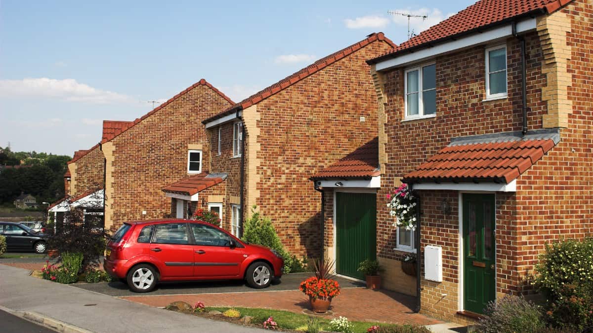 Modern suburban family houses with car on driveway