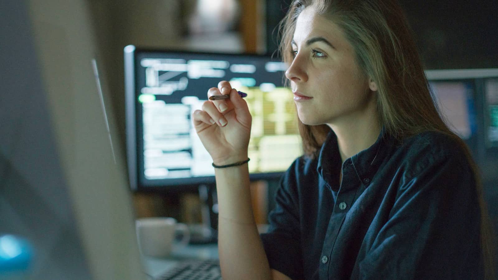 Young female analyst working at her desk in the office