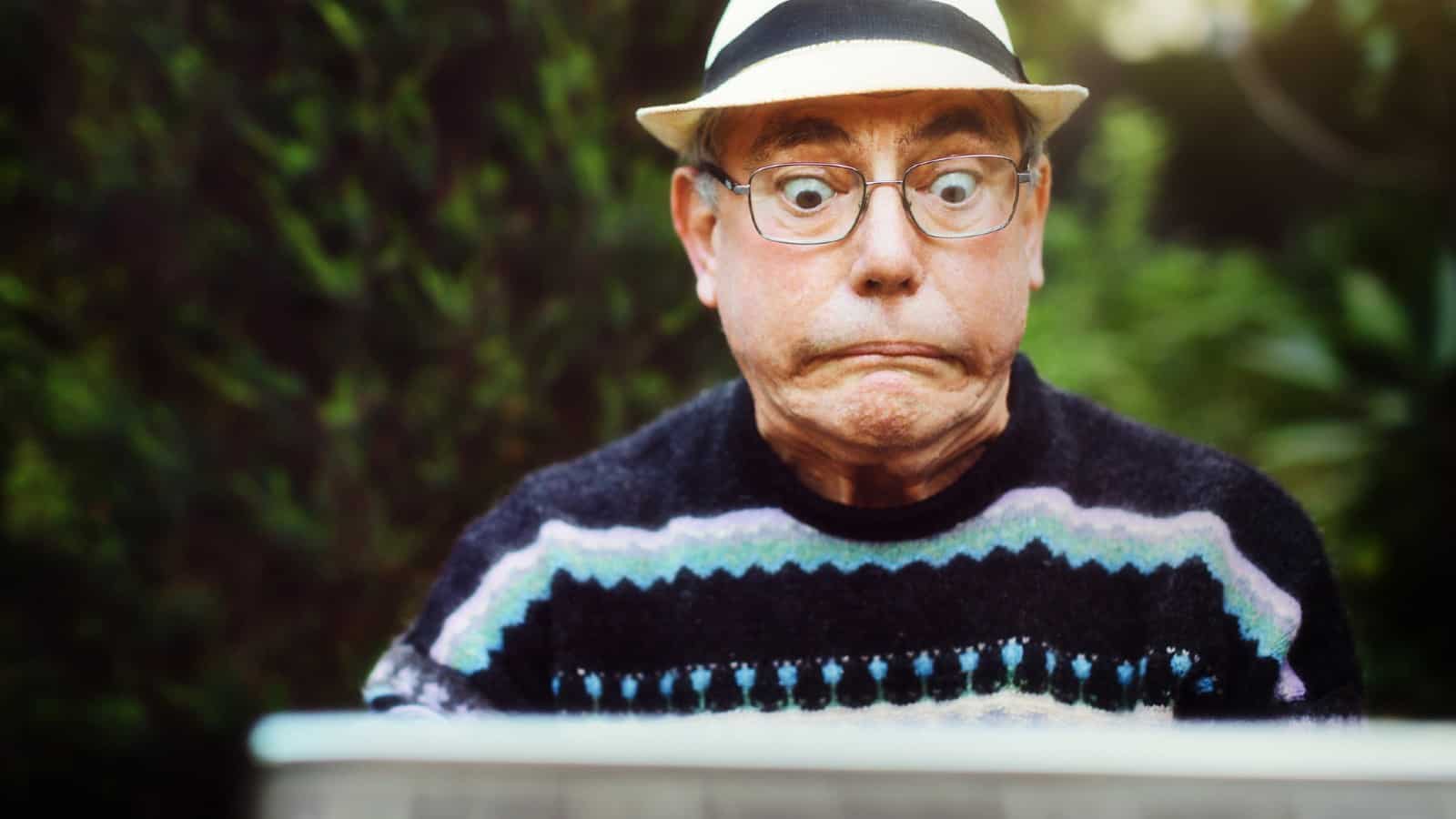 Middle-aged white man pulling an aggrieved face while looking at a screen