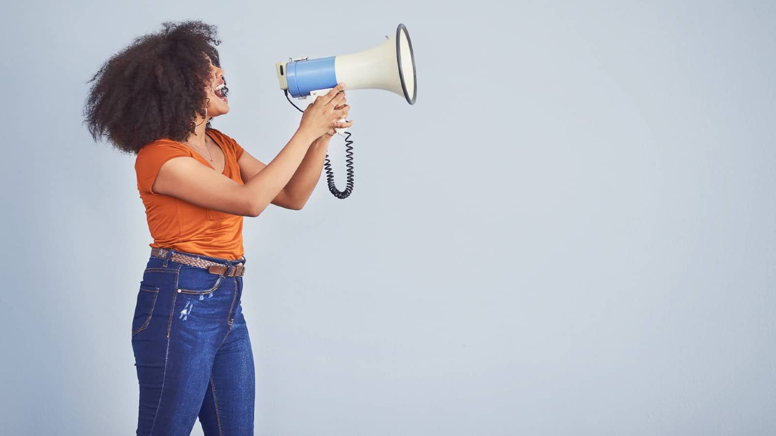 Black woman using loudspeaker to be heard