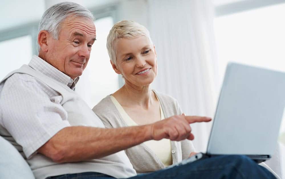 A retired couple review their investing portfolio