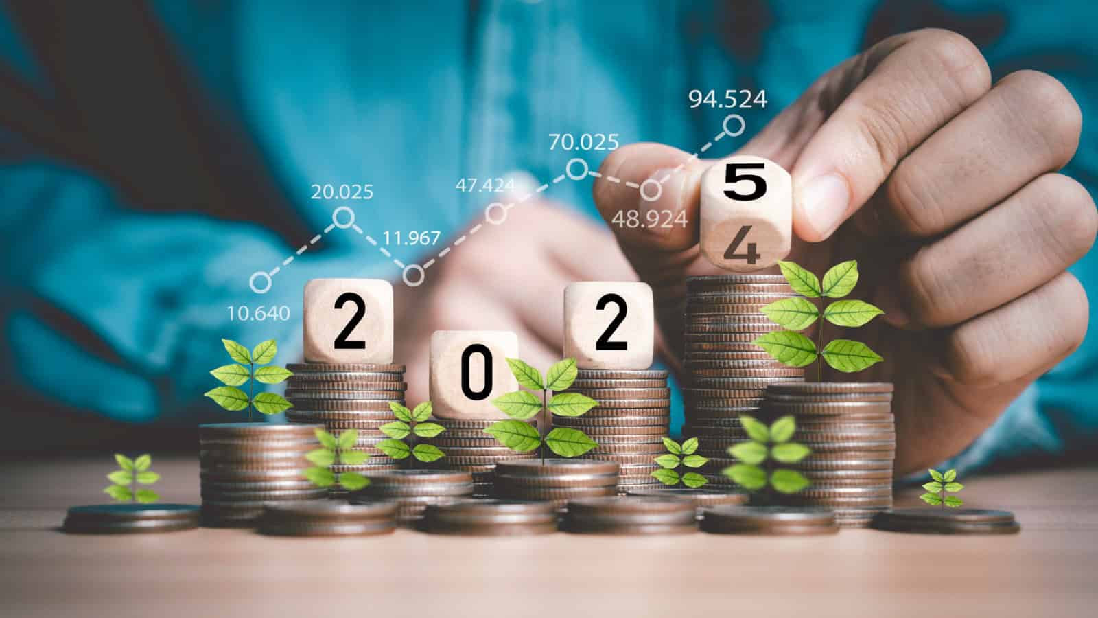 Businessman hand flipping wooden block cube from 2024 to 2025 on coins
