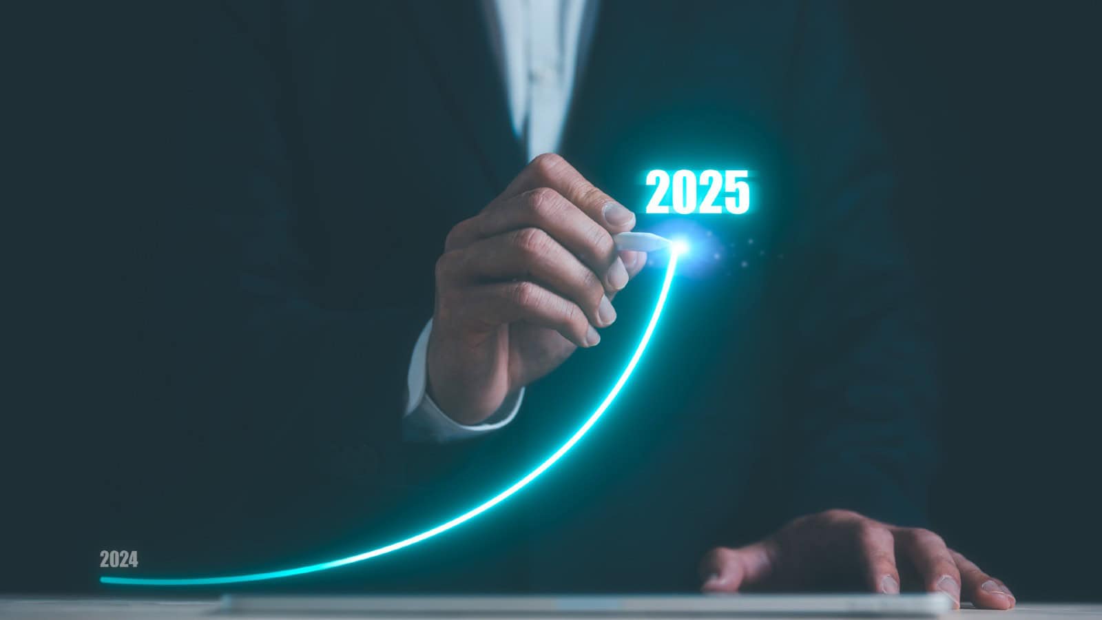 Businessman using pen drawing line for increasing arrow from 2024 to 2025