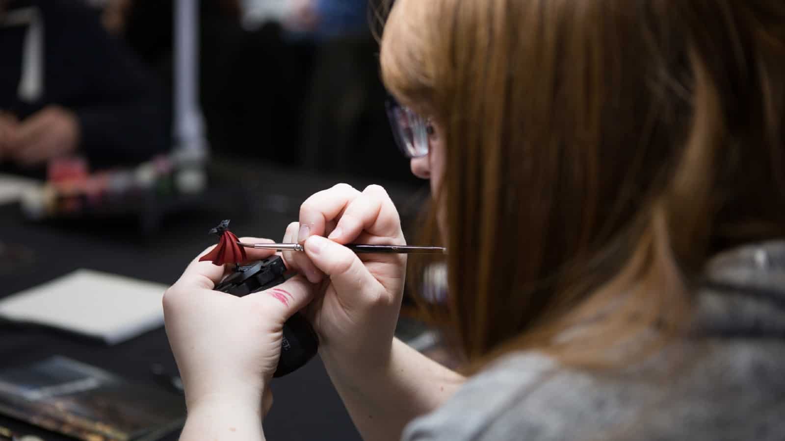 Woman painting a Warhammer model