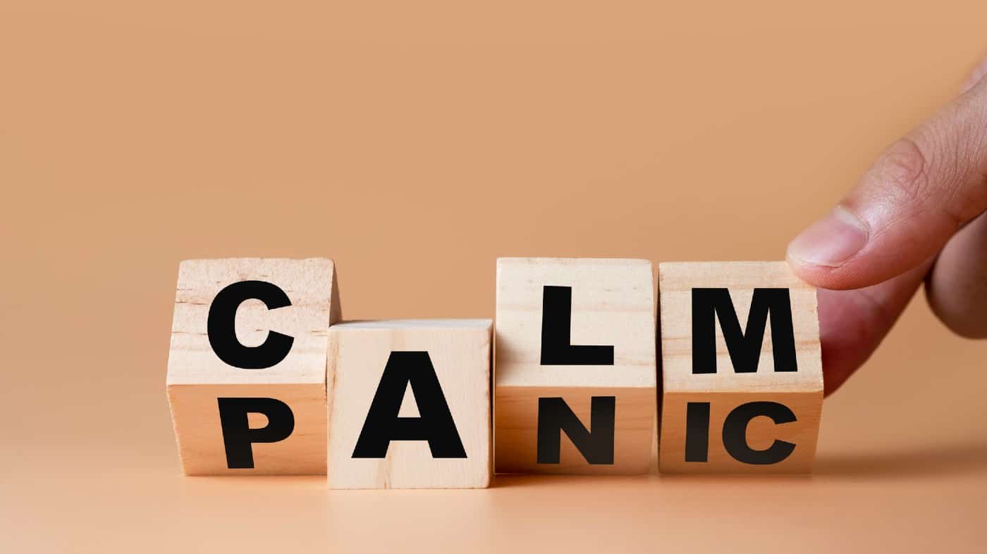 Hand flipping wooden cubes for change wording" Panic" to " Calm".