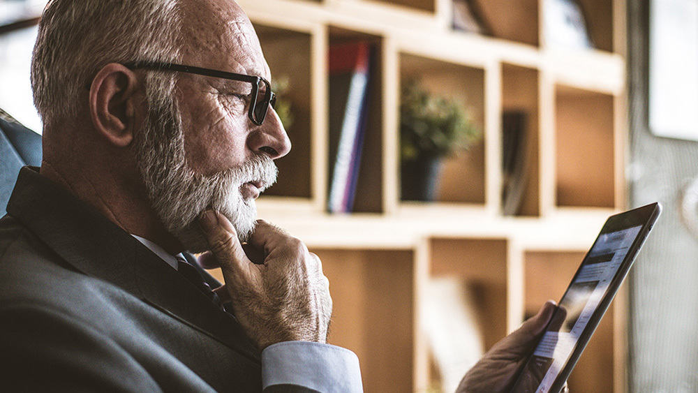 Older Man Reading From Tablet