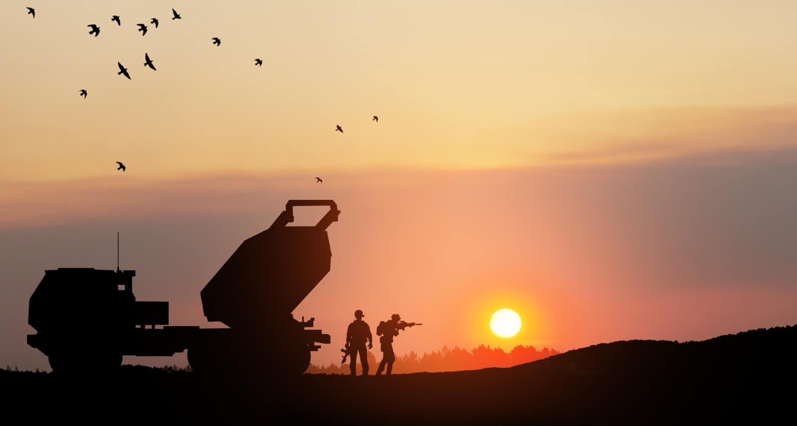 Artillery rocket system aimed to the sky and soldiers at sunset.
